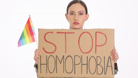 woman protesting homophobia with rainbow pride flag