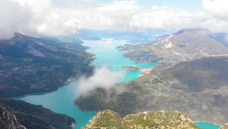 Limni-Kremaston,-Aerial-Panoramic-Footage-of-Kremaston-Lake-Evritania-Greece,-Cloudy-Agrafa-mountains