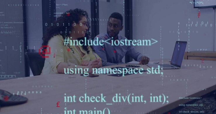 Colleagues studying laptop while pointing at display and initiating C++ code overlays for debugging