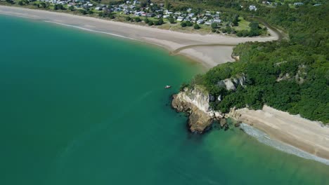 cinematic aerial pan around mountain clifftop in the midday sun