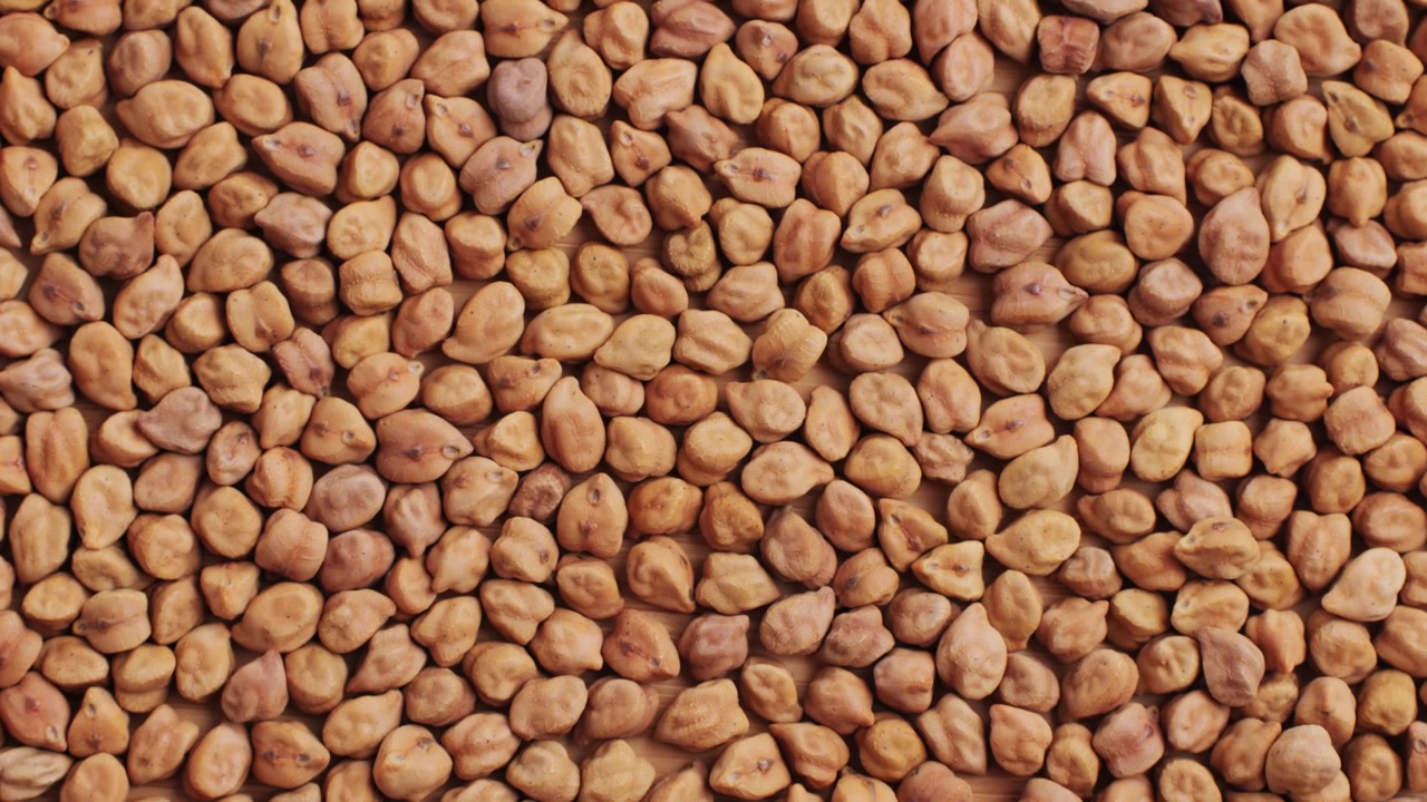 Close-up Overhead View of Dried Chickpeas on a Wooden Surface
