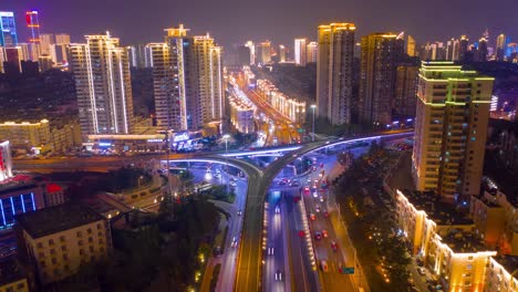 night illumination qingdao city center traffic street road junction aerial timelapse panorama 4k china