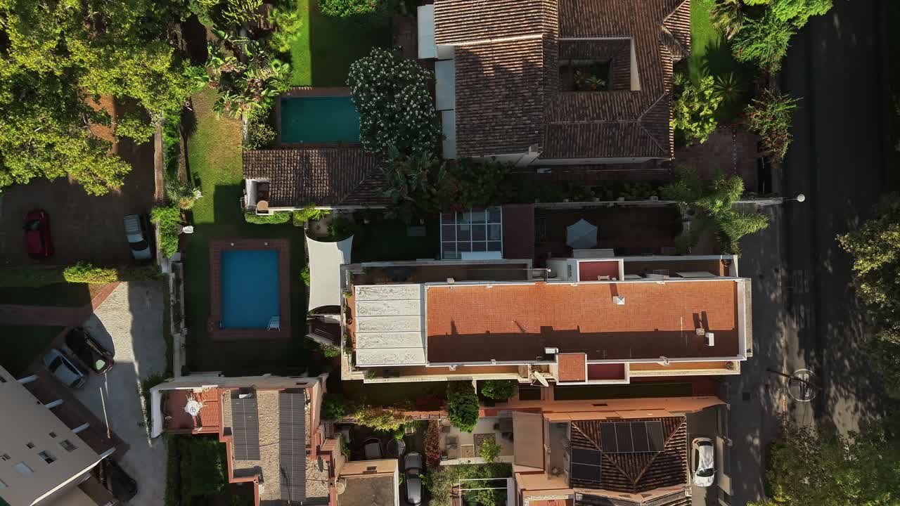 Birds eye view ascending over houses and swimming pools, southern Spain