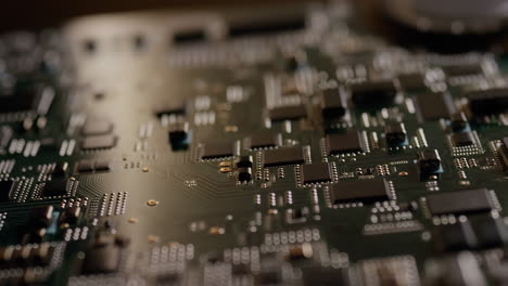 detail of a green printed circuit board with microchips and electronic components