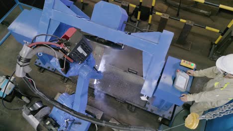robotic welding machine operating on assembly line in production plant. high angle
