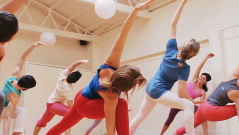 instructor assisting a group of people in exercise