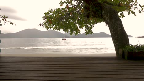 Revealing-traveling-shot-of-beach-and-deck-in-a-beautiful-orange-sunset