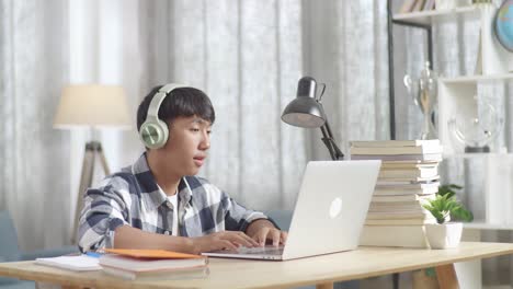 teenager studying online and listening to music