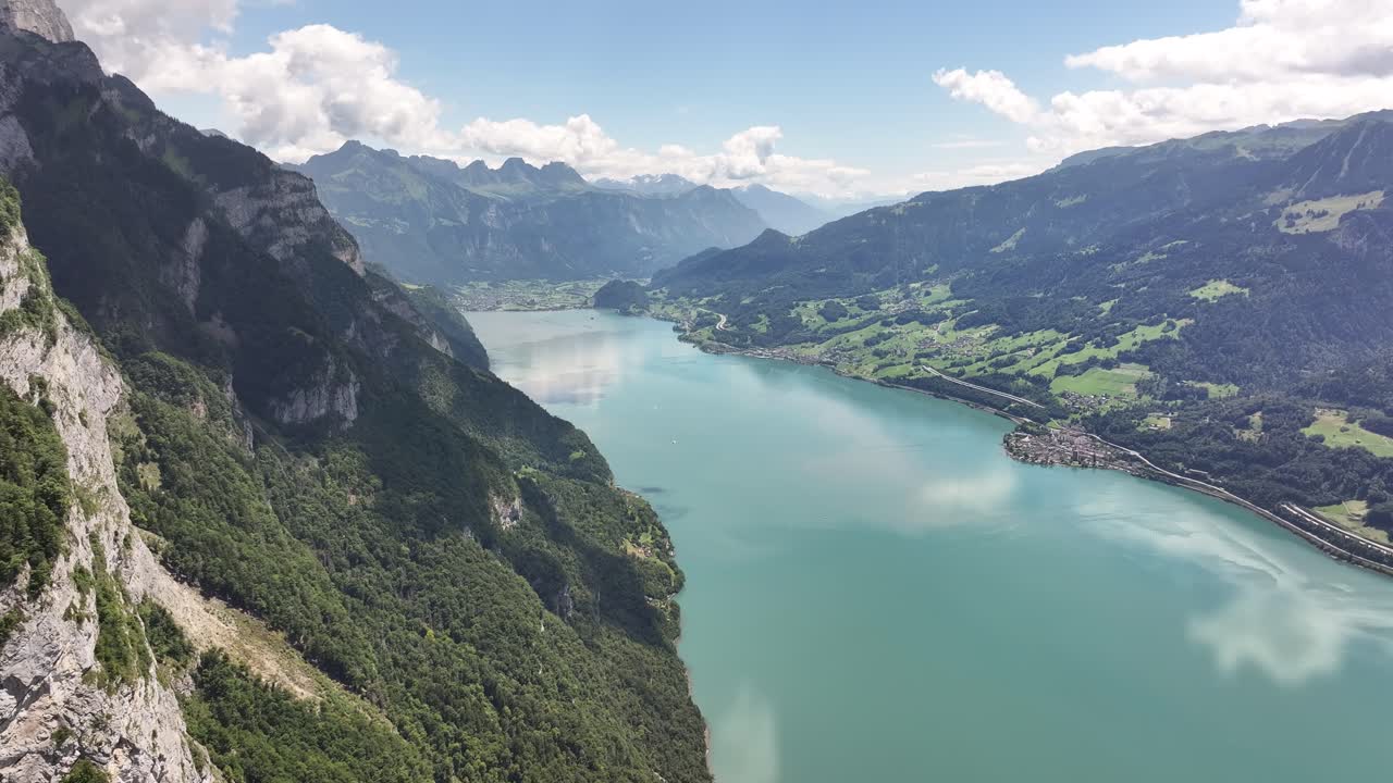 Beautiful and calm lake Walensee. Clear water in the Alpine mountains on a bright sunny day from a drone