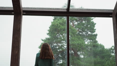 melancholic employee stares out at rain. woman grapples with depression disorder struggles to find solace among challenges of professional life