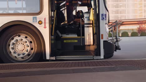 Man-enters-waiting-bus-during-daytime-commute