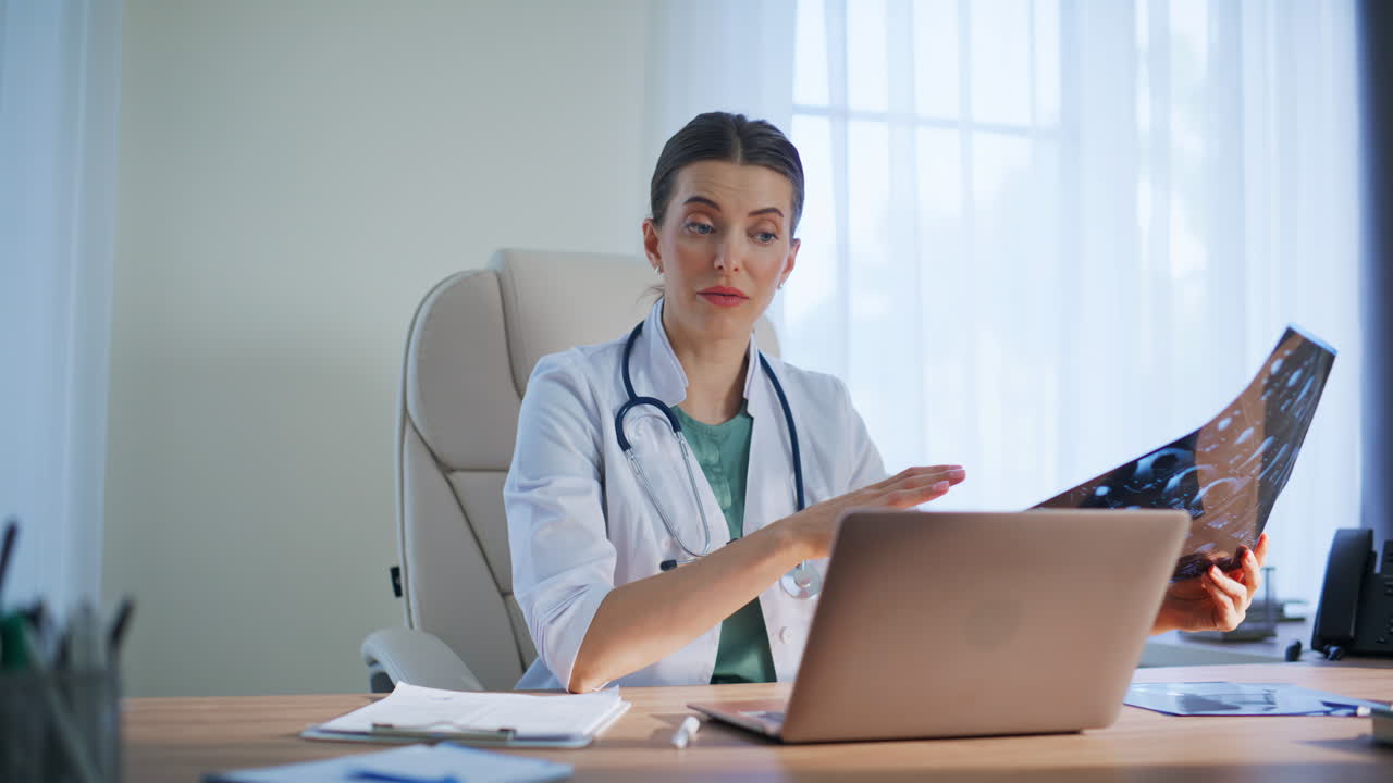 Professional radiologist talking computer in hospital office interior closeup