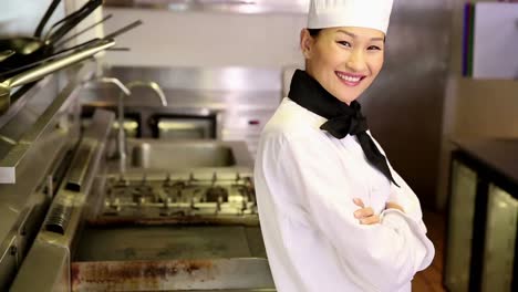 happy chef smiling at camera beside the stove