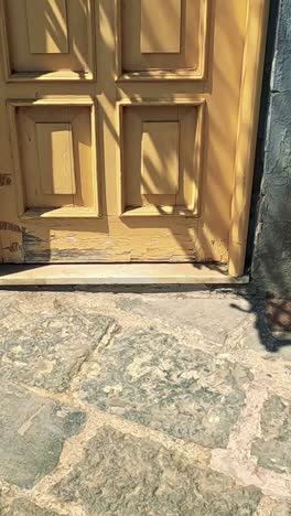 a wooden door with shadows in sorrento, italy