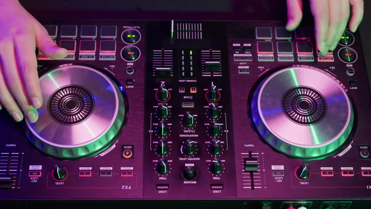 DJ with headphones and sunglasses playing music on festival in night club. Techno musician performing at nightclub for concert crowd of people, city bar.