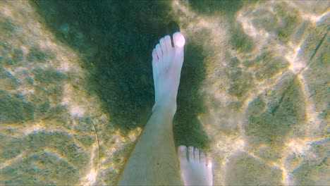 White-Male-Feet-Walk-on-Sand-Bottom-of-Lake,-Wide-Underwater-Close-Up