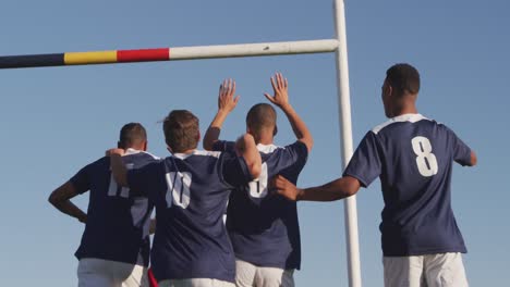 rugby players celebrating on the field