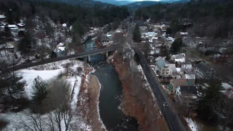 aerial flight with a scenic view of ottauquechee river in winter, woodstock, vermont