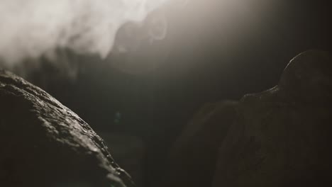close up view of rocks in the smoke, mountains at night