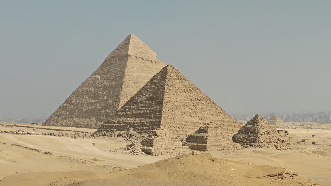 A panorama of the Giza Necropolis featuring the three principal pyramids built for Pharaohs Khufu, Khafre, and Menkaure, surrounded by the desert landscape
