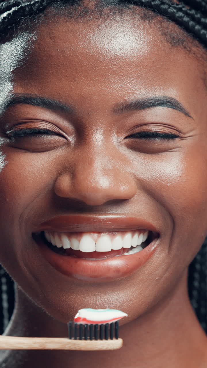 Close-up of Happy Young Woman Smiling with Toothbrush and Toothpaste