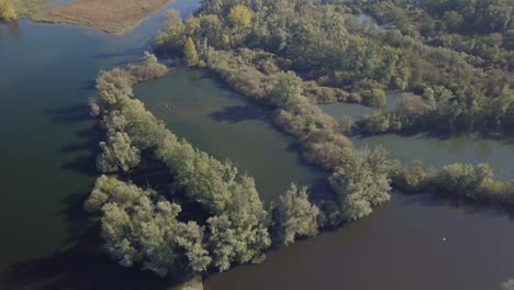 aerial drone view of flying over the small islands at the lake in the netherlands, europe
