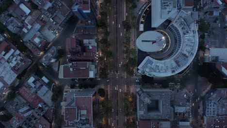 aerial birds eye overhead top down view of traffic on wide street after sunset. quick shot change on cityscape and back. mexico city, mexico