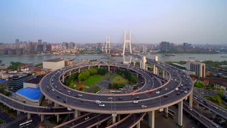 aerial view of nanpu bridge, shanghai downtown, china. financial district and business centers in smart city in asia. top view of skyscraper and high-rise buildings at sunset.