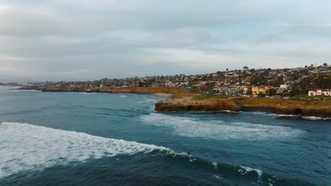 Surfer-Surfing-At-The-Pacific-Ocean-Near-The-Sunset-Cliffs-In-Point-Loma,-San-Diego,-California