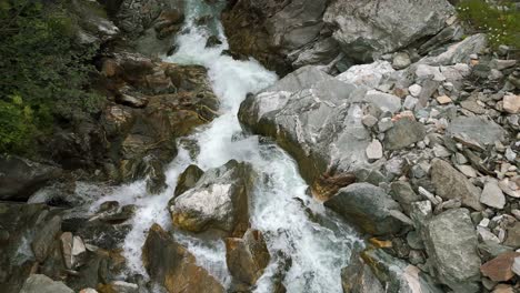 high angle ascending view of waterfall and river stream flowing in switzerland