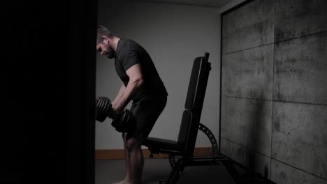 Seated-dumbbell-shoulder-press,-cinematic-lighting,-white-man-dressed-in-black-gym-attire