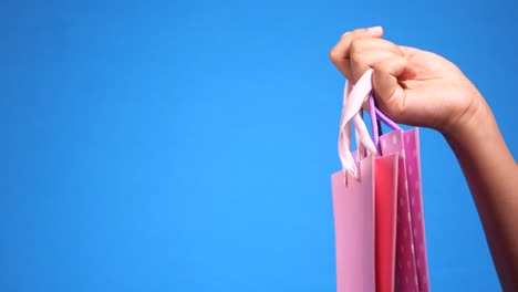 woman holding pink shopping bags