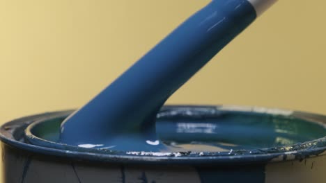 close up of pvc pipe stirring and pulling out of blue paint