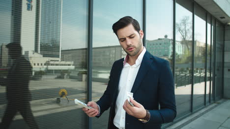 Closeup-businessman-counting-cash-at-street.-Man-throwing-money-in-suit-outside