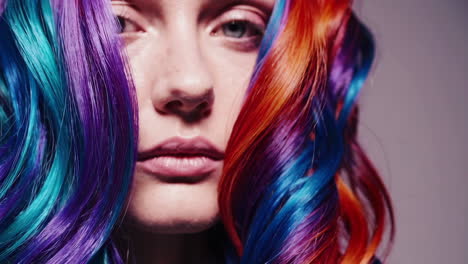 Woman with vibrant rainbow colored curly hair