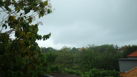 Slow-motion-wide-shot-of-heavy-rain-on-a-balcony-in-Uluwatu,-Bali