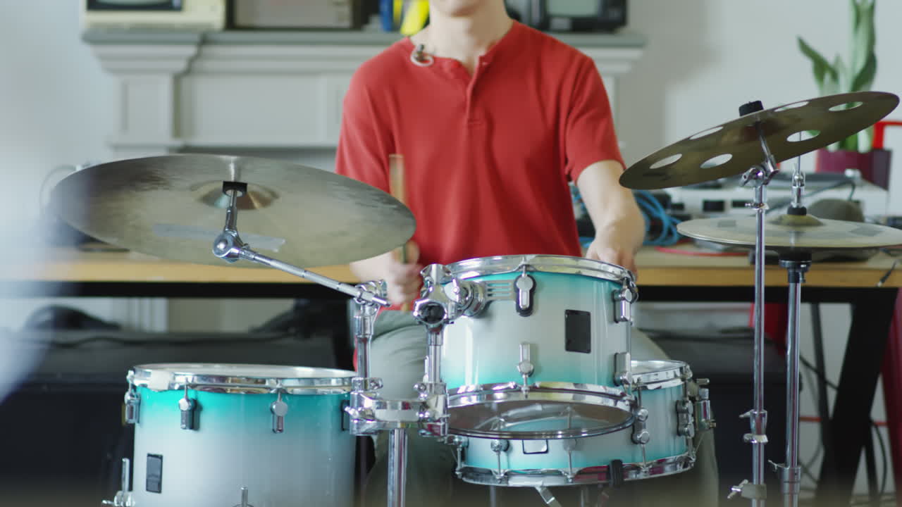 A person playing drums and upright bass