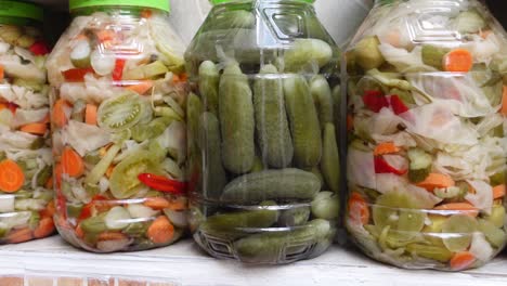 assortment of pickled vegetables in glass jars