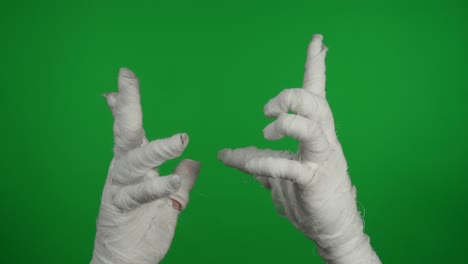 detail green screen isolated chroma key video capturing mummy's hand holding a smartphone and
