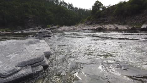 Water-Flows-through-Stone-River-Valley-Sky-Landscape,-Coast-of-Córdoba-Argentina