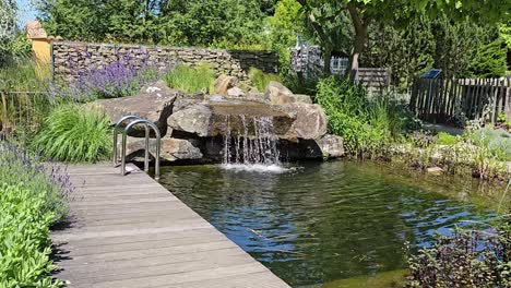 a small stream of water flows over a rock wall