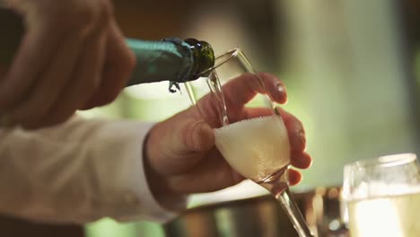 a man is pouring champagne into a glass