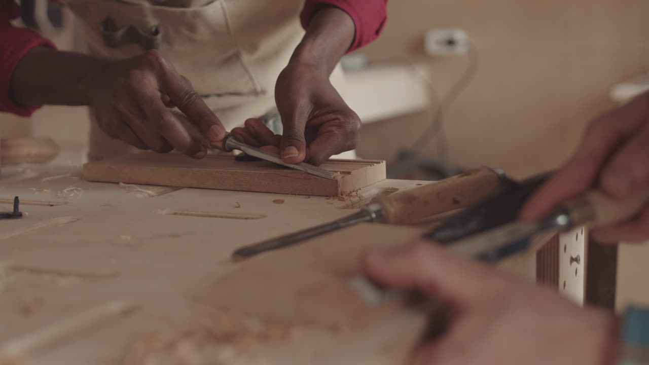 Two Craftsmen Carving Wood