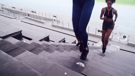 women running up stadium stairs