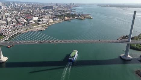 Cebu-Cordova-Link-Expressway,-Passenger-Ferry-passing-below-arriving-in-Cebu-Port