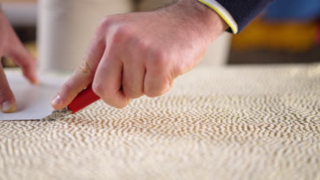cutting paper with a knife