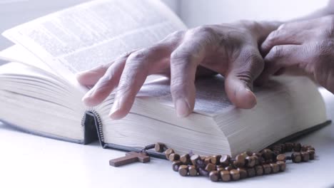 praying to god with hand on bible with white background with people stock footage