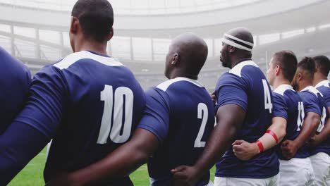 Male-rugby-players-taking-pledge-together-in-stadium-4k