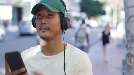 a young man listening to music while out