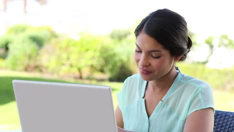 Businesswoman-having-coffee-while-working-on-laptop